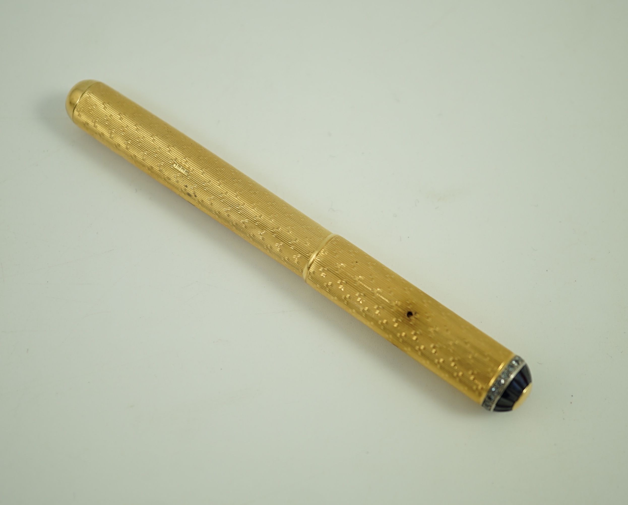 A late 1930's 18ct gold cased and sapphire and diamond set side lever fountain pen, 11cm